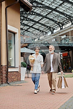 happy elderly couple, shopping, bouquet of