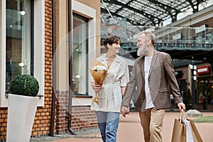 happy elderly couple during shopping, flowers