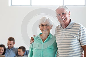 Happy elderly couple smiling at camera