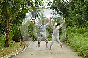 Happy elderly couple in tropical forest