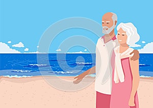 Happy elderly couple walking along the beach by the sea
