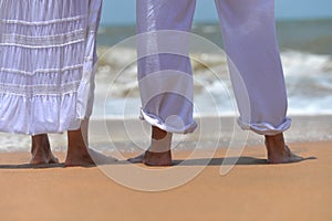 Happy elderly couple walking on tropical beach