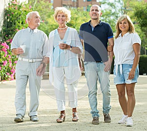 happy elderly friends walking outdoor