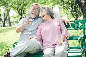 Happy elderly with lifestyle after retiree concept. Lovely asian seniors couple embracing together in the park in the