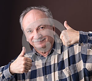 Happy elderly man showing ok sign