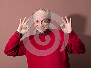 Happy elderly man showing ok sign