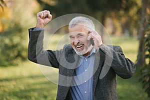 Happy elderly man speak with somebody by the phone. Handsome senior man with beautiful beard smile and rejoice