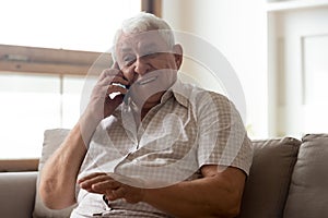 Happy elderly man talk using modern smartphone gadget