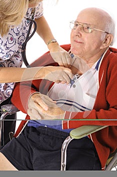 Happy elderly man in wheelchair checking vitals photo