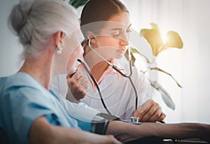 Happy Elderly patient talk with woman doctor at room in hospital. Doctor use stethoscope listening lung of elderly patient.