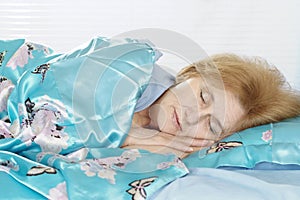 Happy elderly woman in bed