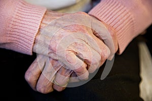 Happy elderly woman close up of hands