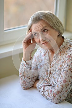 Happy elderly woman at home