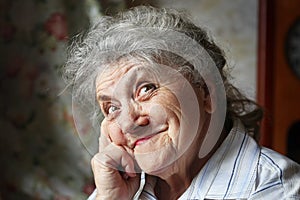 Happy elderly woman portrait on a dark background