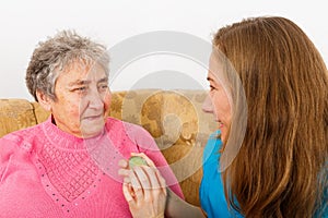 Happy elderly woman and young caregiver