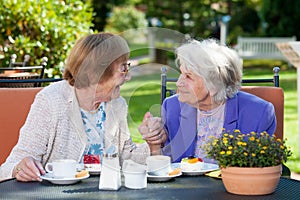 Happy Elderly Women Chatting at the Garden Table