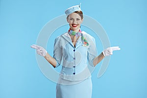 happy elegant air hostess woman on blue gesturing