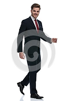 Happy elegant businessman smiling and walking