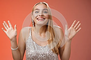 Happy elegant dreamy glamour young blond woman raising hands delight joyfully smiling camera glad see friends comming