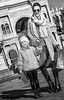Happy elegant mother and daughter traveller in Milan, Italy