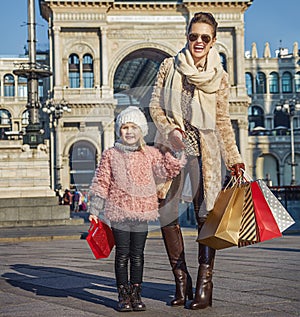 Happy elegant mother and daughter traveller in Milan, Italy