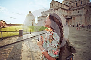 Happy elegant traveller woman in floral dress