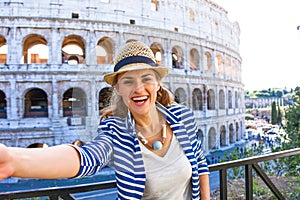 Happy elegant traveller woman in Rome, Italy taking selfie