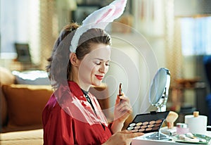 Happy elegant woman with bunny ears makeup for easter