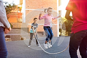Children playing with skipping rope photo