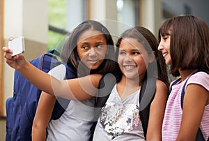 Happy elementary school friends, children and selfie for fun educational memory in lobby together. Diversity, young