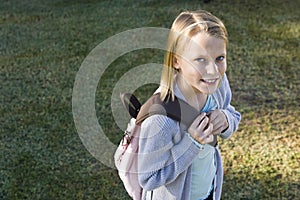 Happy elementary school girl with her bookbag