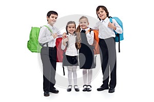 Happy elementary school kids with colorful back packs