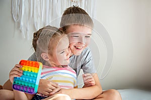 Happy embrace of brother and sister, relationship between boy and girl in the family