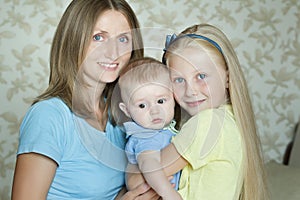 Happy embracing family members posing for indoor portrait