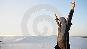 Happy Emirate man walks on outskirts of desert with smile on fac