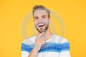 Happy emotional guy close up. Positive emotions. Happy man on yellow background. Bearded man smiling. Man with mustache