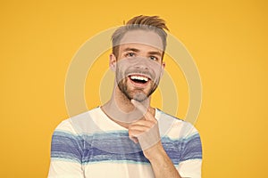 Happy emotional guy close up. Positive emotions. Happy man on yellow background. Bearded man smiling. Man with mustache