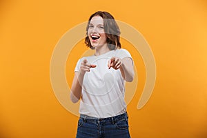 Happy emotional young woman pointing to you.