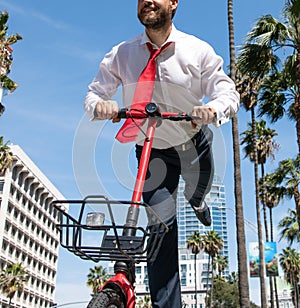 Happy employee have fun scooting along city street, escooter photo