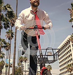 Happy employee have fun scooting along city street, escooter photo