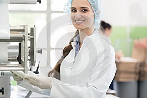 Happy employee wearing lab coat while handling sterile wipes in