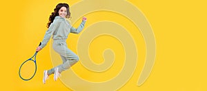 happy energetic child jump in sportswear with squash racquet on yellow background, sport success. Horizontal poster of