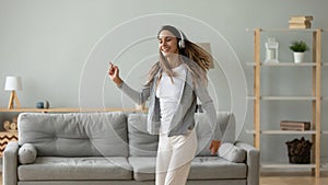 Happy energetic young mixed race woman dancing.