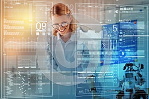 Smiling engineer looking at the documents while working in her office
