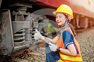 happy engineer women worker check service maintenance train wheel suspension confirm thumbs up good condition photo