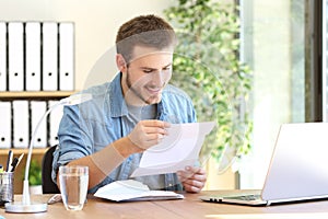 Happy entrepreneur reading a letter photo