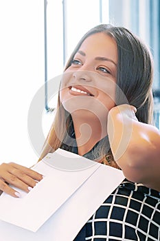 Happy entrepreneur woman reading good news in a letter