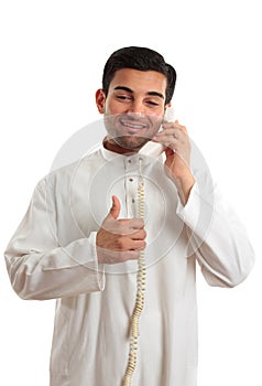 Happy ethnic businessman on phone