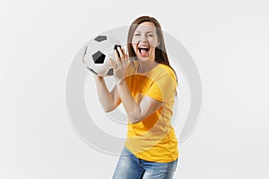 Happy European young woman, football fan or player in yellow uniform holding soccer ball support favorite team isolated