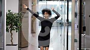 Happy excited african american business woman triumphing after job interview photo
